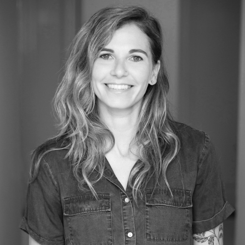 Jordan Pyers smiling in a black-and-white headshot